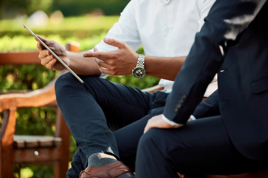 Two people going through a plan on a tablet